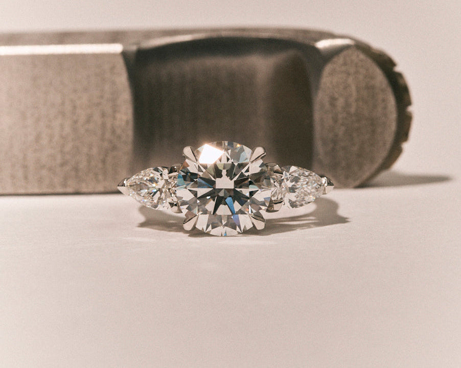 A loose diamond held in jeweller's tweezers