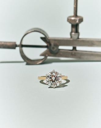 Cambon Round Brilliant Six Claw Solitaire Swept Shoulder Engagement Ring