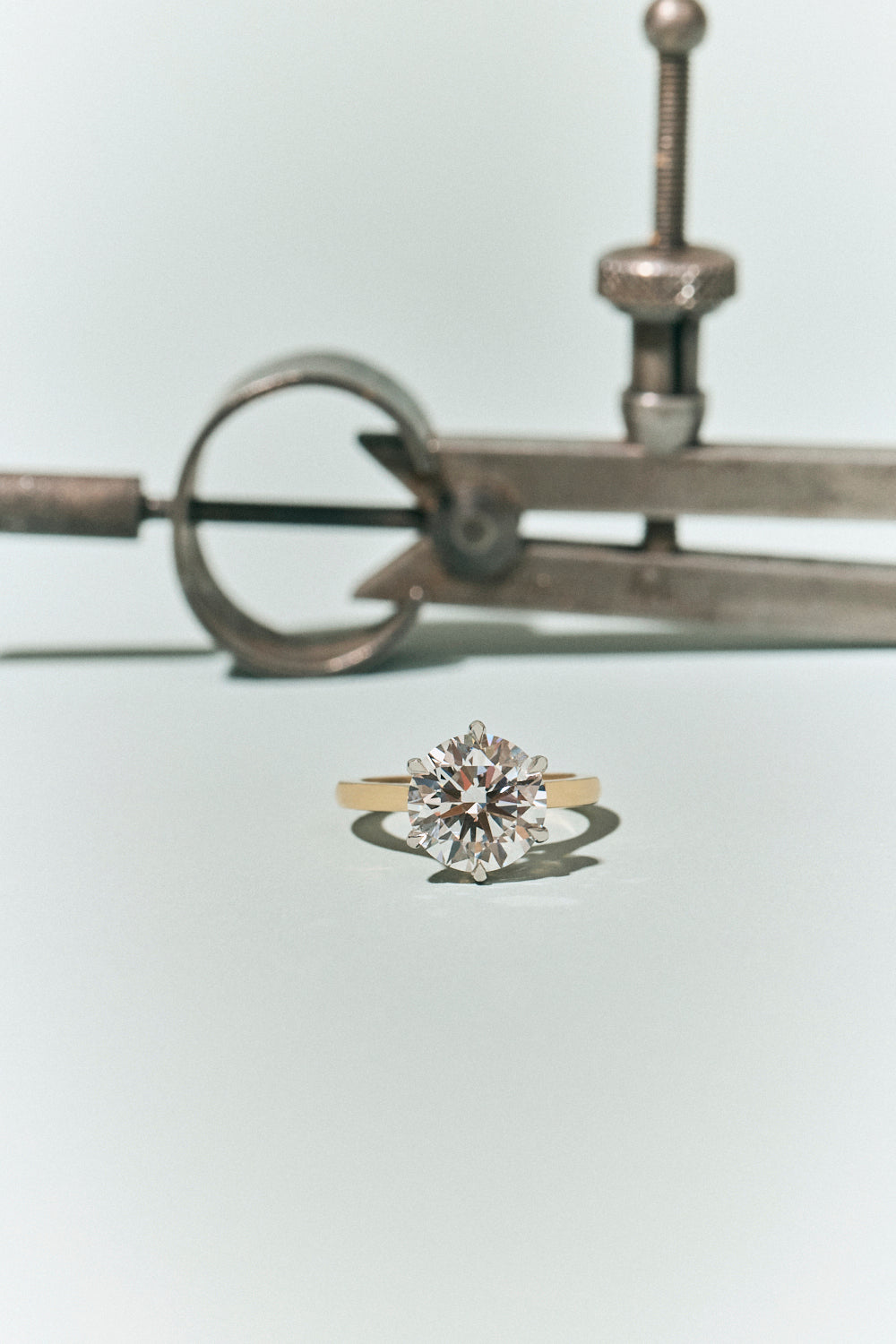 Cambon Round Brilliant Six Claw Solitaire Swept Shoulder Engagement Ring
