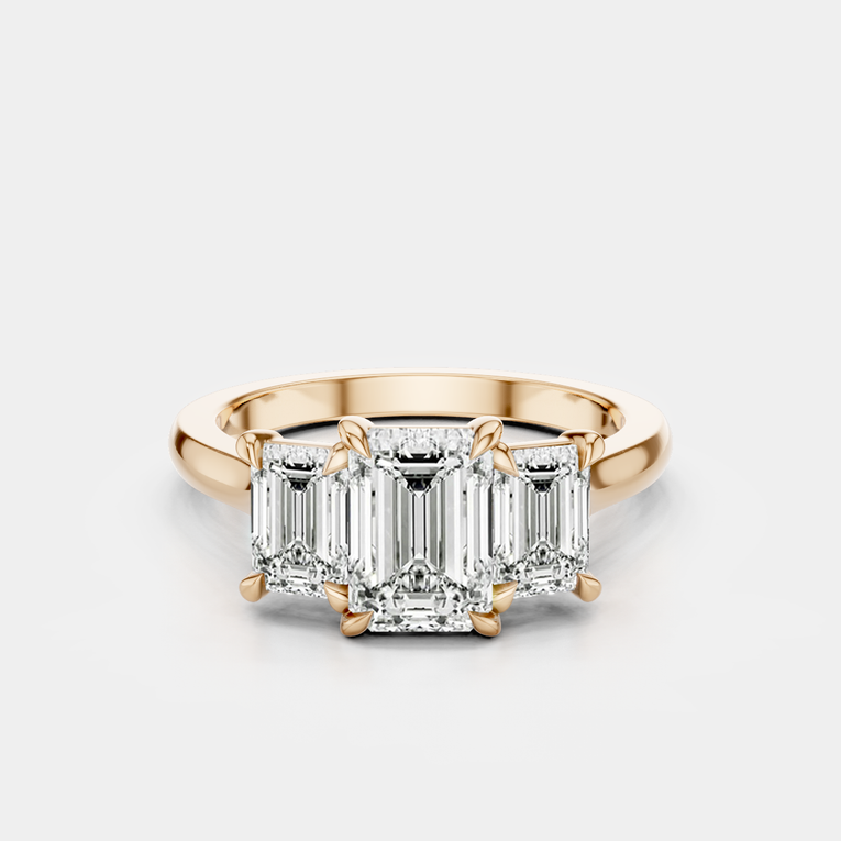Marion emerald cut trilogy engagement ring in 18ct rose gold