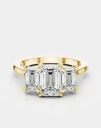 Marion emerald cut trilogy engagement ring in 18ct yellow gold