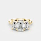 Marion emerald cut trilogy engagement ring in 18ct yellow gold