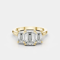 Marion emerald cut trilogy engagement ring in 18ct yellow gold
