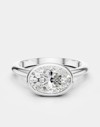 Maddox oval solitaire bezel east-west engagement ring in 18ct white gold