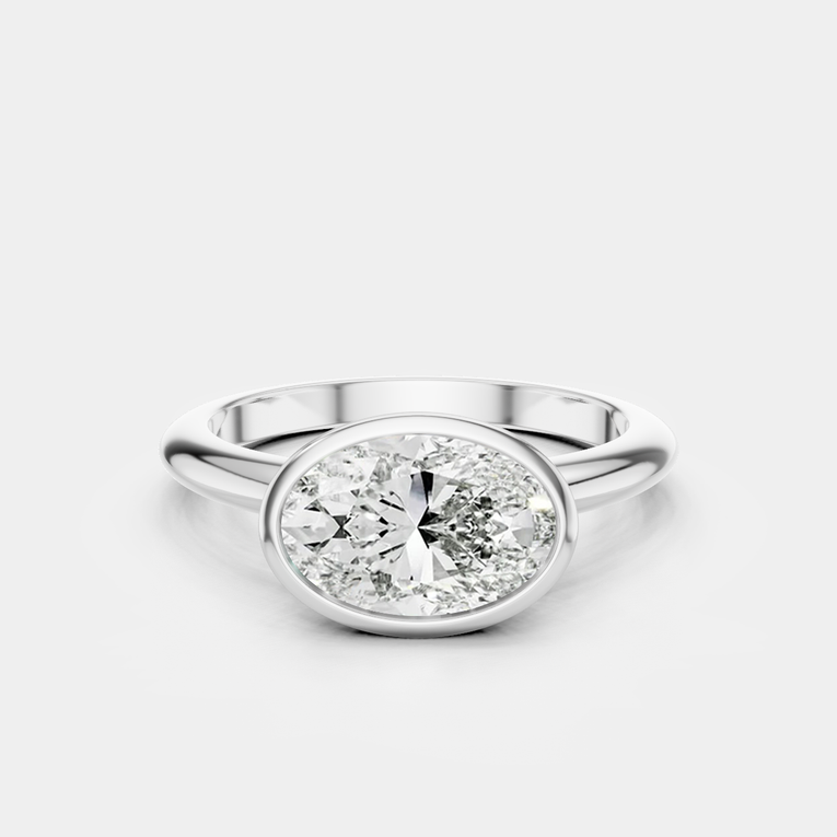 Maddox oval solitaire bezel east-west engagement ring in 18ct white gold