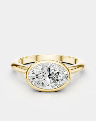 Maddox oval solitaire bezel east-west engagement ring in 18ct yellow gold