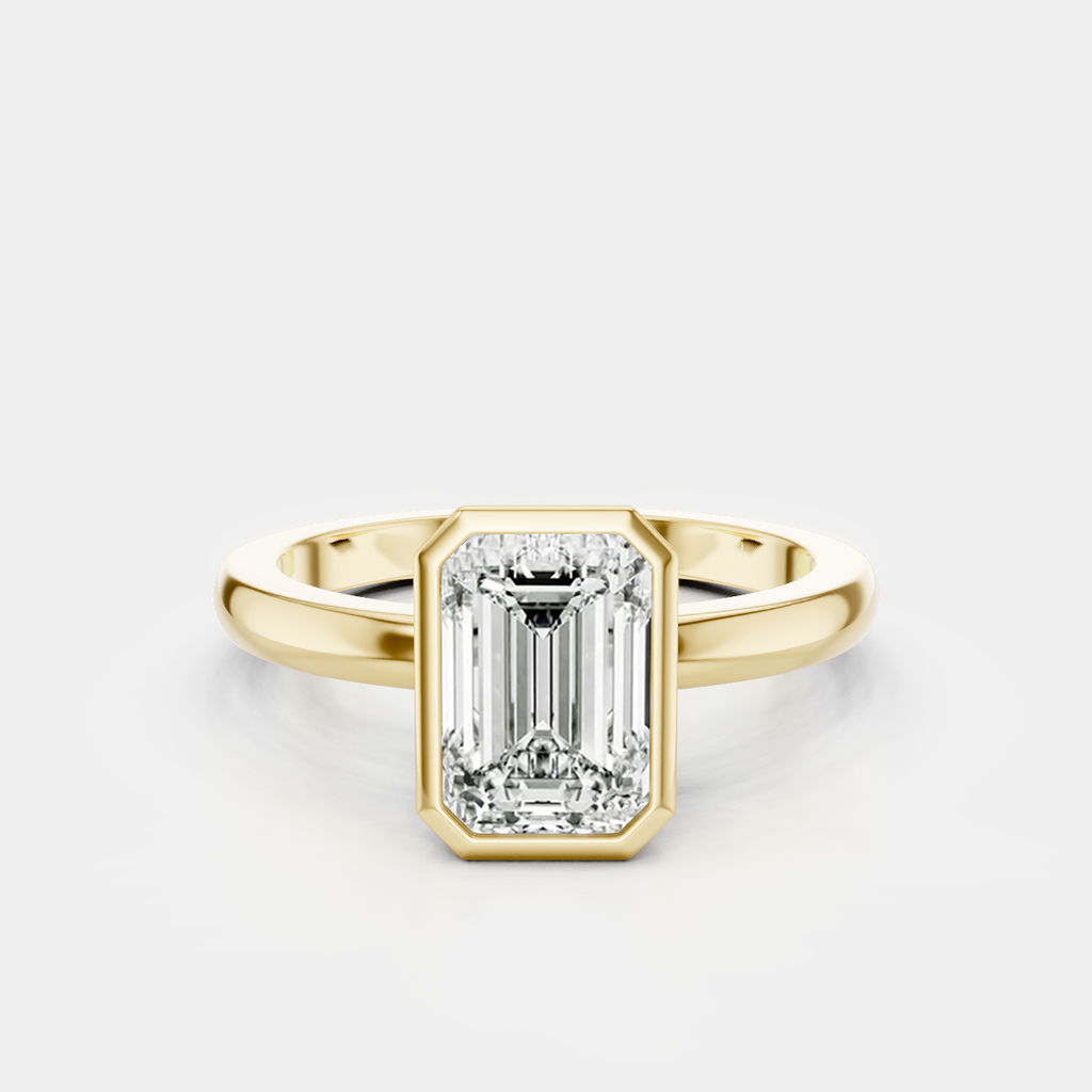 Sutton emerald cut solitaire bezel north-south engagement ring in 18ct yellow gold