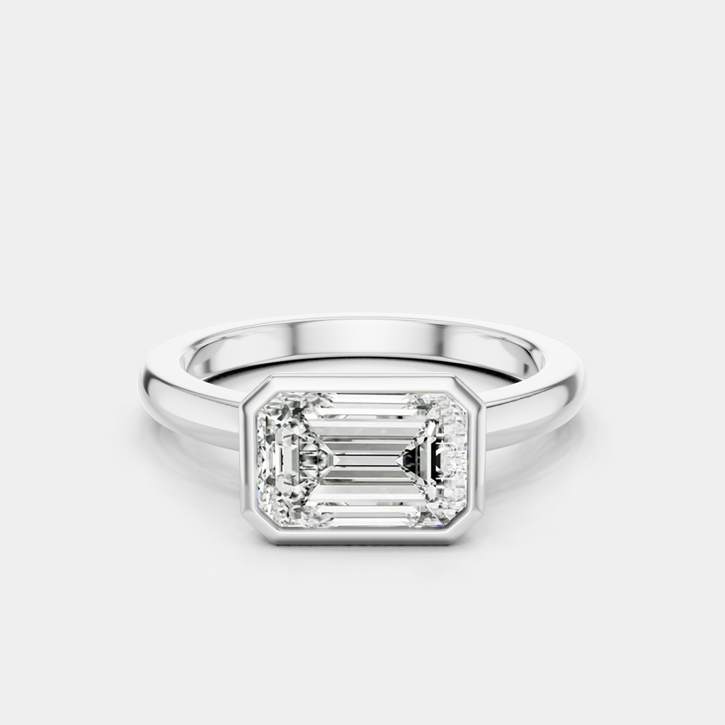 Rowan emerald cut solitaire bezel East-West engagement ring in 18ct white gold