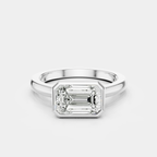 Rowan emerald cut solitaire bezel East-West engagement ring in 18ct white gold