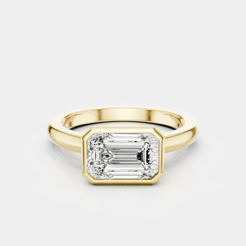 Rowan emerald cut solitaire bezel East-West engagement ring in 18ct yellow gold
