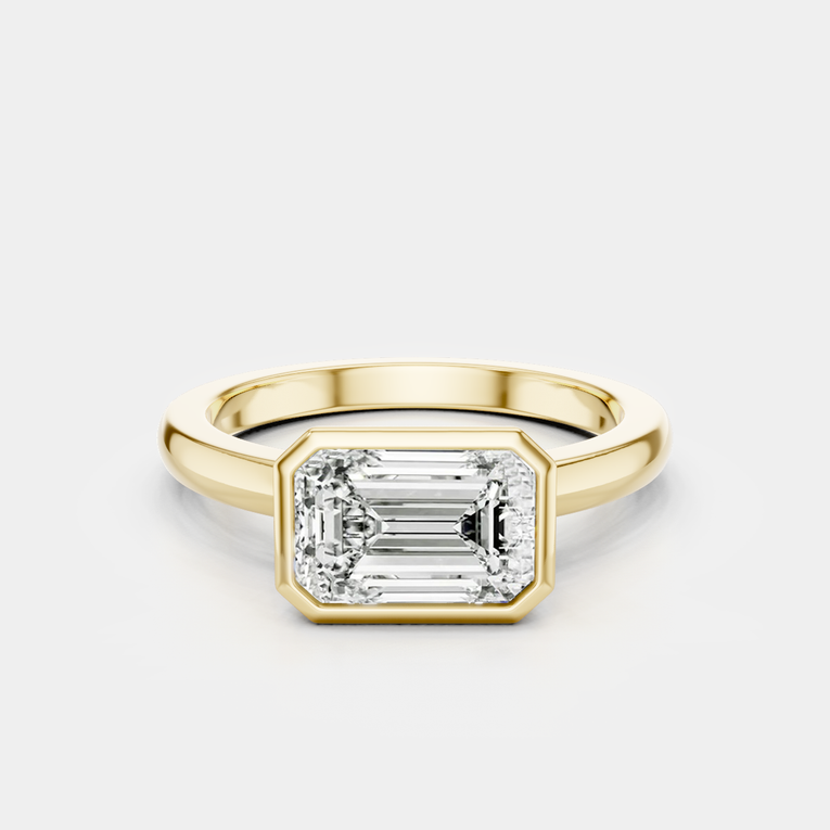 Rowan emerald cut solitaire bezel East-West engagement ring in 18ct yellow gold