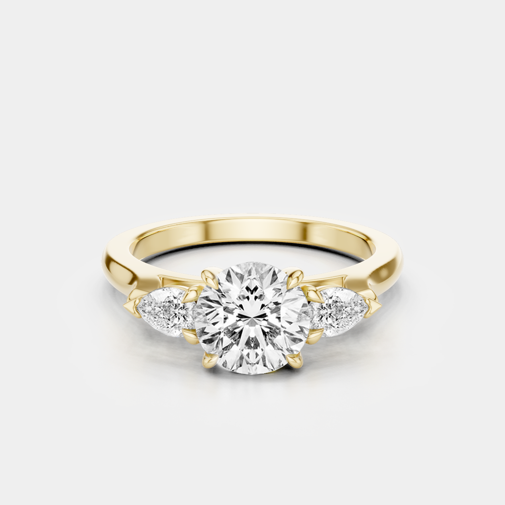 Cornelia round brilliant pear side stone engagement ring in 18ct yellow gold