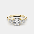 Cornelia round brilliant pear side stone engagement ring in 18ct yellow gold