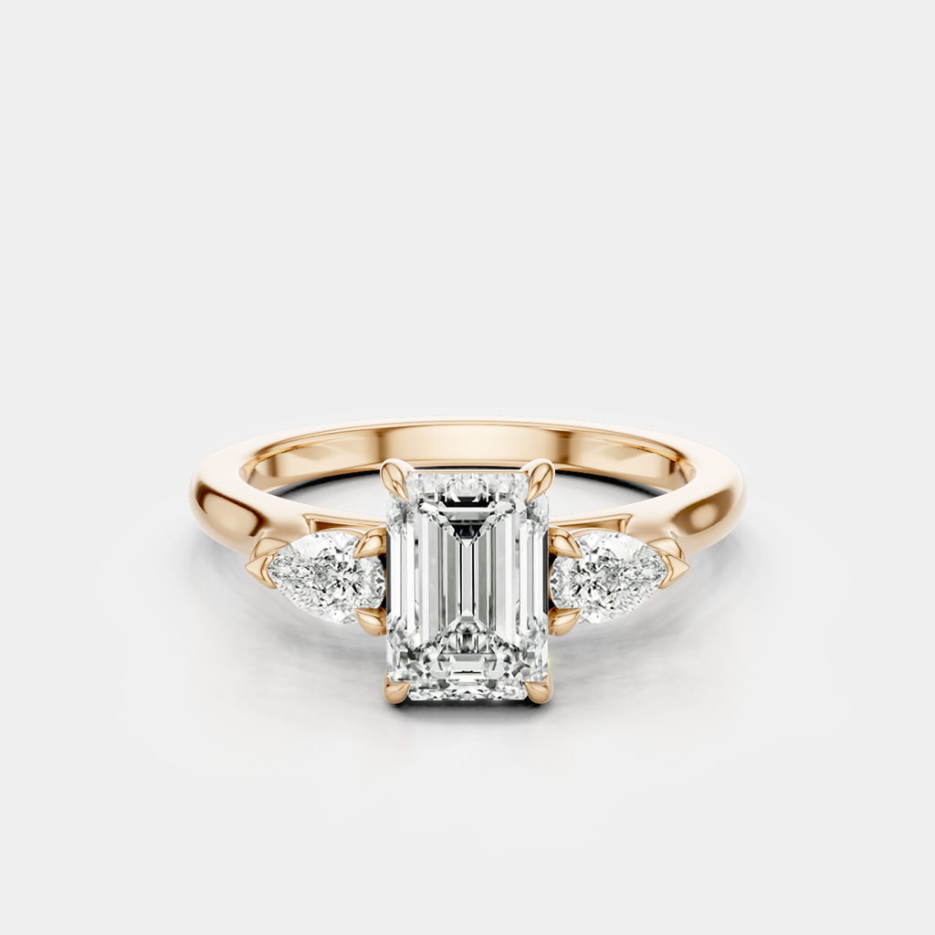 Bruton emerald cut pear side stone engagement ring in 18ct rose gold