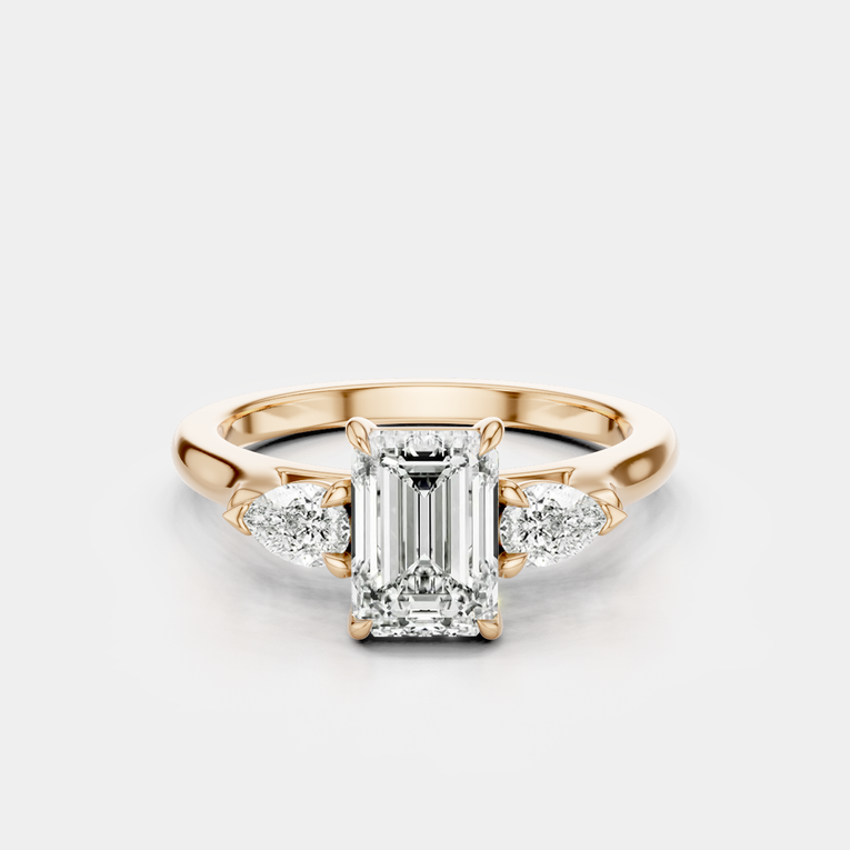 Bruton emerald cut pear side stone engagement ring in 18ct rose gold