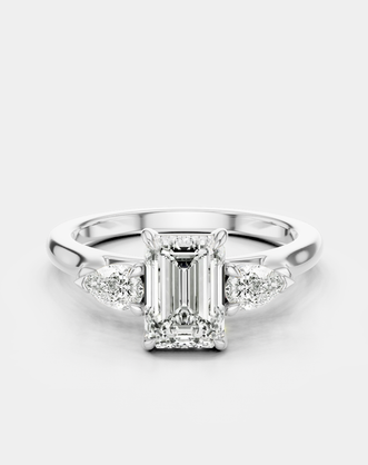 Bruton emerald cut pear side stone engagement ring in 18ct white gold