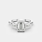 Bruton emerald cut pear side stone engagement ring in 18ct white gold