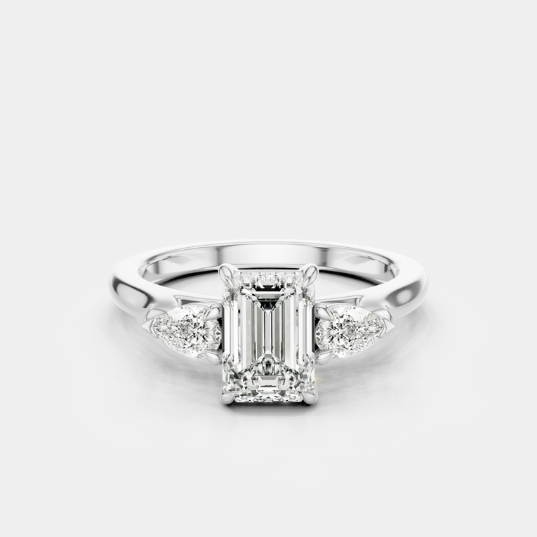 Bruton emerald cut pear side stone engagement ring in 18ct white gold