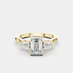 Bruton emerald cut pear side stone engagement ring in 18ct yellow gold