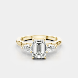 Bruton emerald cut pear side stone engagement ring in 18ct yellow gold