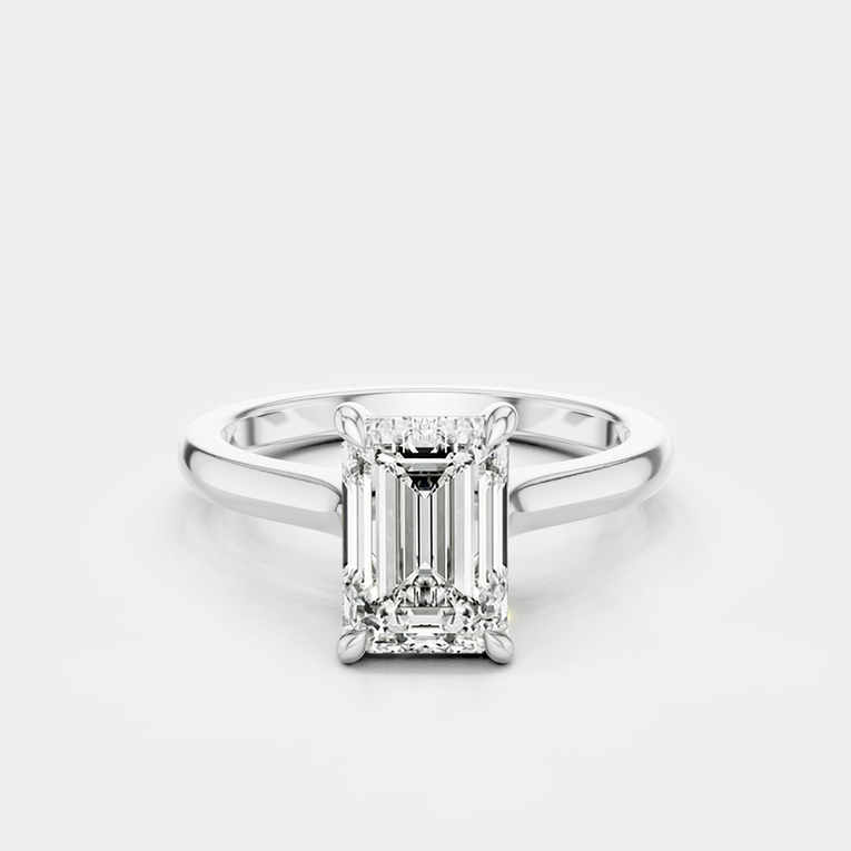 Dover emerald cut solitaire swept shoulder engagement ring in 18ct white gold