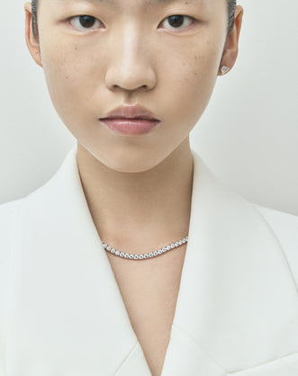 Model wearing Lucile round brilliant claw set tennis necklace 20ct
