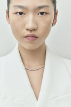 Model wearing Lucile round brilliant claw set tennis necklace 20ct