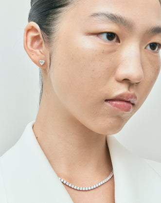 Model wears Kensington 1ct heart shape diamond studs in 18ct white gold