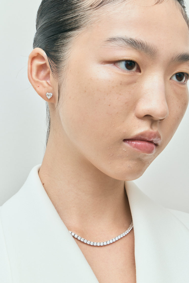 Model wears Kensington 1ct heart shape diamond studs in 18ct white gold