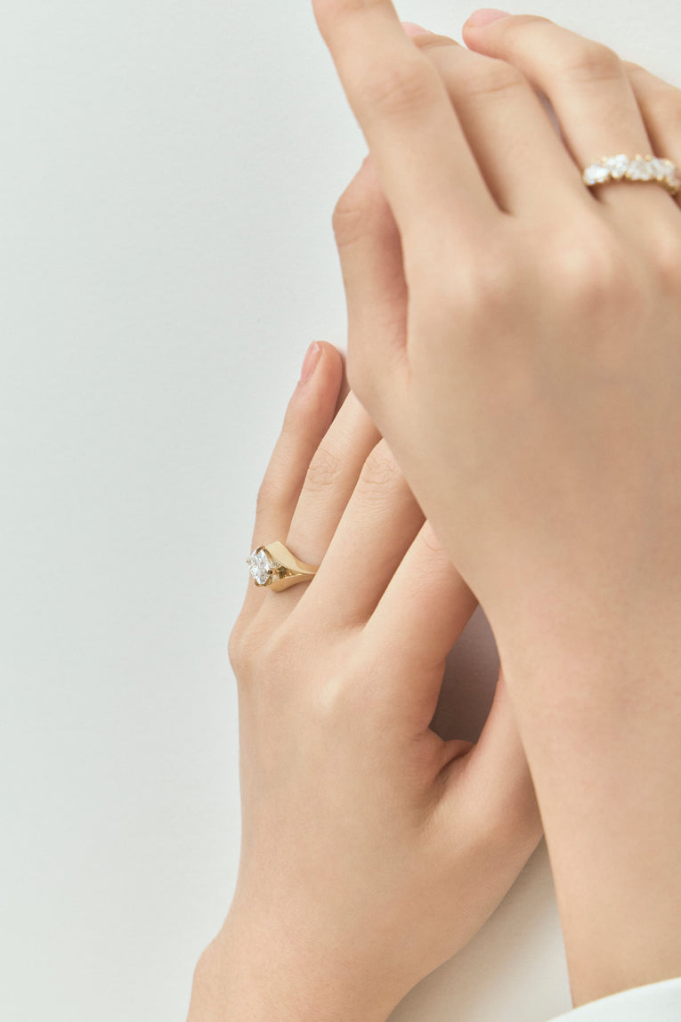 Model wears Mercer East-West 3ct marquise solitaire engagement ring in 18ct yellow gold