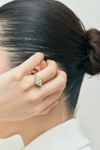 Model wears Mercer East-West 3ct marquise solitaire engagement ring in 18ct yellow gold