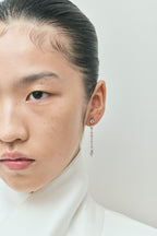 Model wears Noho mixed shape statement drop earrings in 18ct yellow gold 