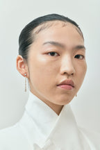 Model wears Noho mixed shape statement drop earrings in 18ct yellow gold 