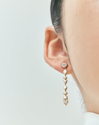 Model wears Noho mixed shape statement drop earrings in 18ct yellow gold 