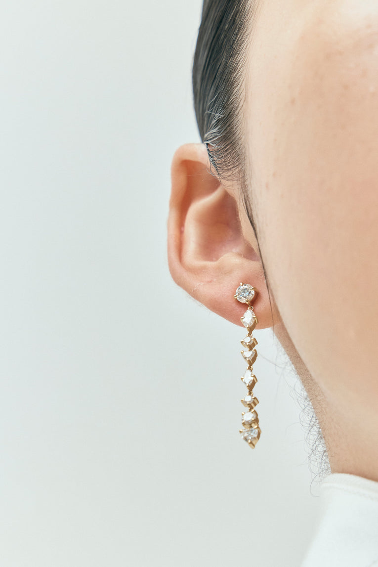 Model wears Noho mixed shape statement drop earrings in 18ct yellow gold 