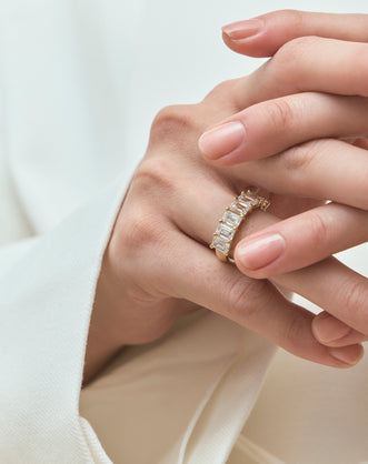 Model wears Soho 0.50ct emerald cut half eternity band in 18ct yellow gold