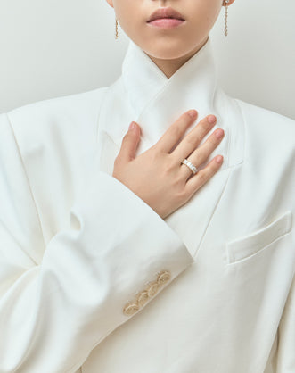 Model wears Soho 0.50ct emerald cut half eternity band in 18ct yellow gold