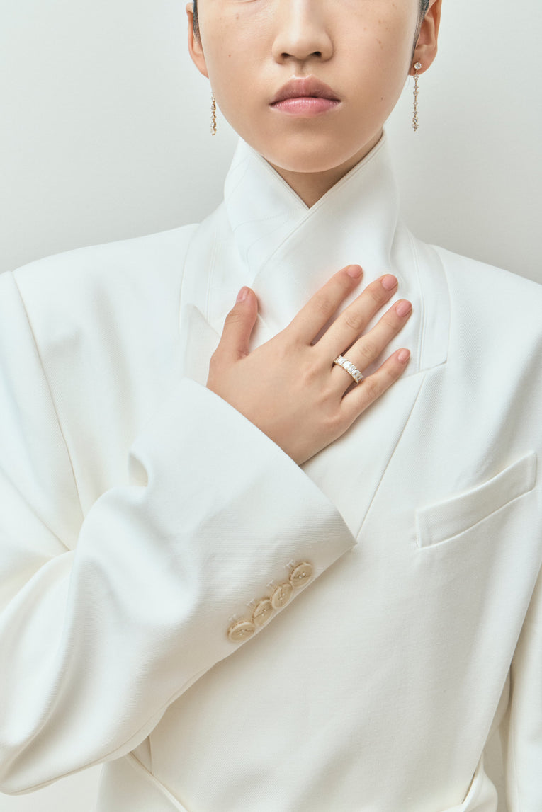 Model wears Soho 0.50ct emerald cut half eternity band in 18ct yellow gold