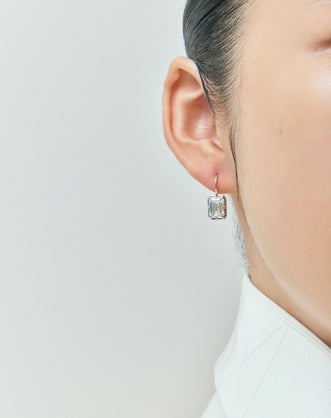 Model wears Avalon 2ct emerald cut button drop earrings in 18ct yellow gold
