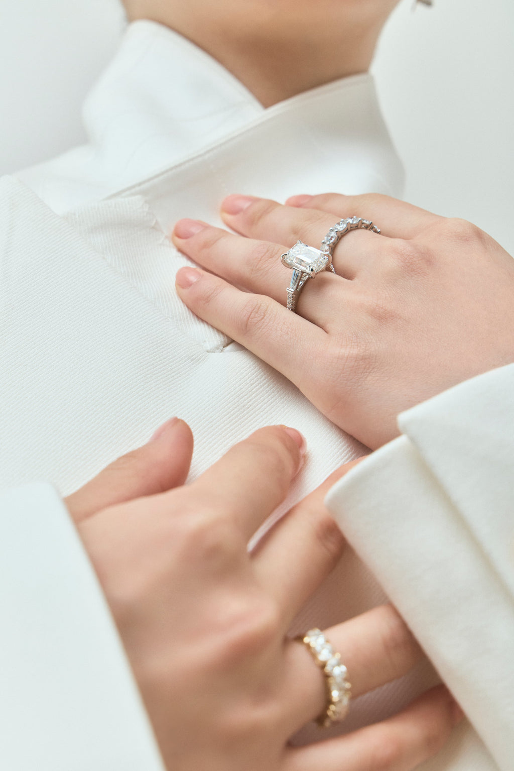 Model wears Elizabeth 5ct emerald cut tapered baguette engagement ring in 18ct white gold