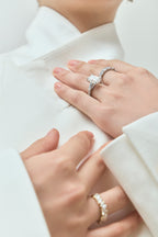 Model wears Elizabeth 5ct emerald cut tapered baguette engagement ring in 18ct white gold