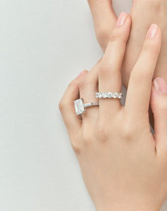 Model wears Elizabeth 5ct emerald cut tapered baguette engagement ring in platinum 