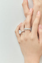 Model wears Elizabeth 5ct emerald cut tapered baguette engagement ring in platinum 