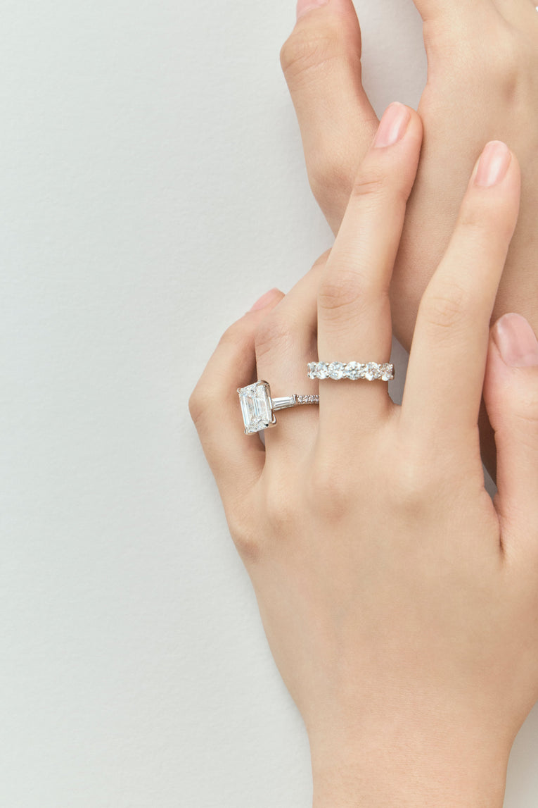 Close-up model wears Cheyne 0.20ct round brilliant half eternity band in 18ct white gold