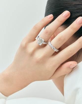 Close-up model wears Cheyne 0.20ct round brilliant half eternity band in 18ct white gold