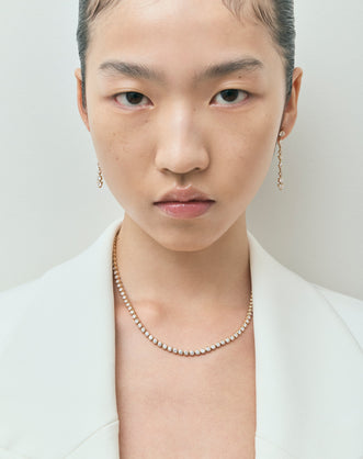 Model wearing York bezel set tennis necklace in 18ct yellow gold