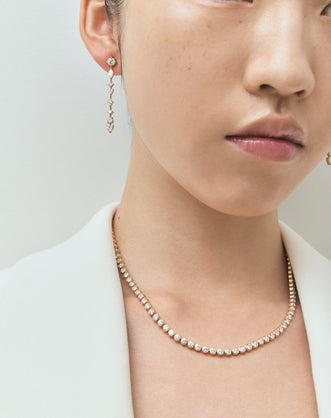 Model wears York bezel set tennis necklace in 18ct yellow gold
