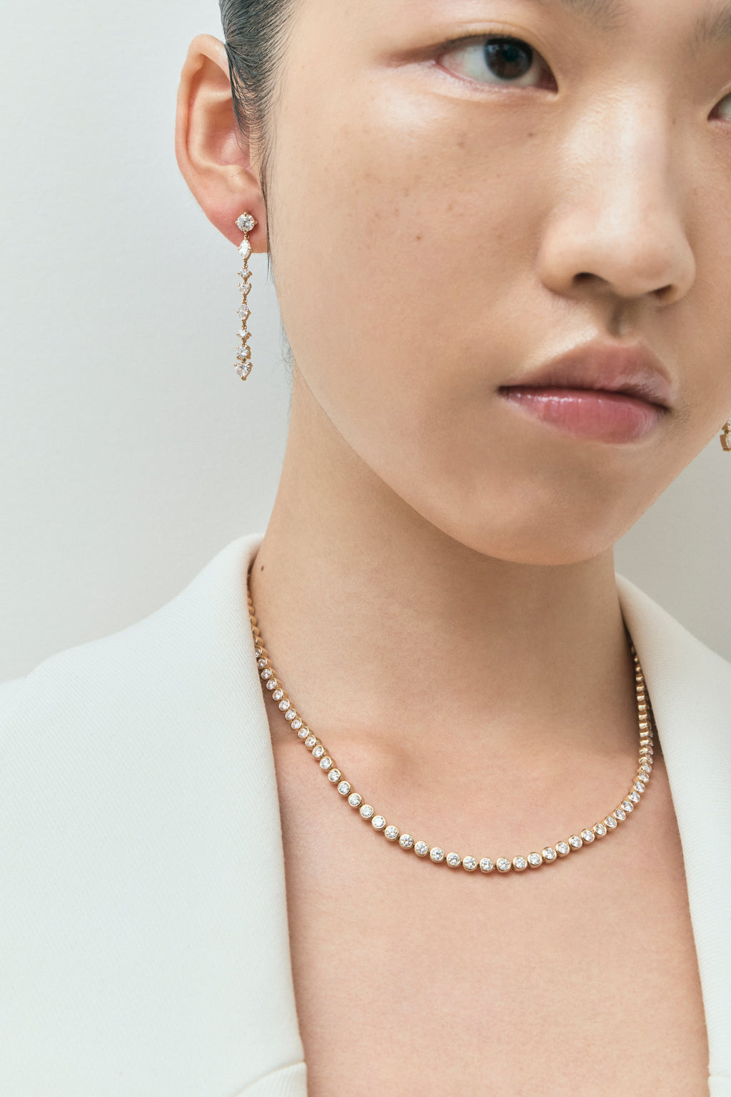 Model wears York bezel set tennis necklace in 18ct yellow gold