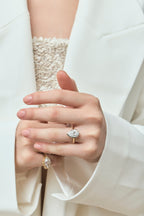 Model wears Vestry 3ct pear solitaire scalloped engagement ring in 18ct yellow gold