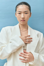 Model wears Cheyne 0.30ct round brilliant half eternity band in 18ct white gold